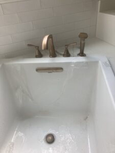 Plumber repairing bathtub drain