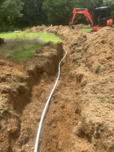 Plumber repairing outdoor water line