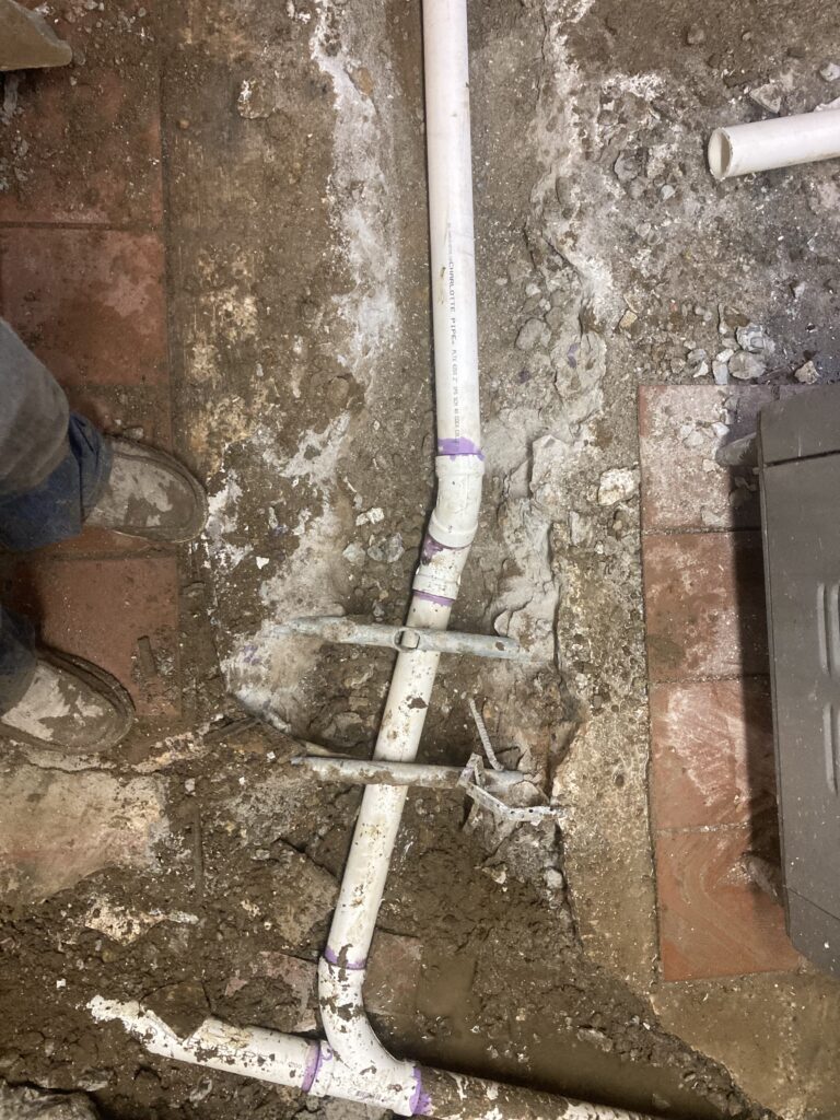 Technician inspecting underground sewer line