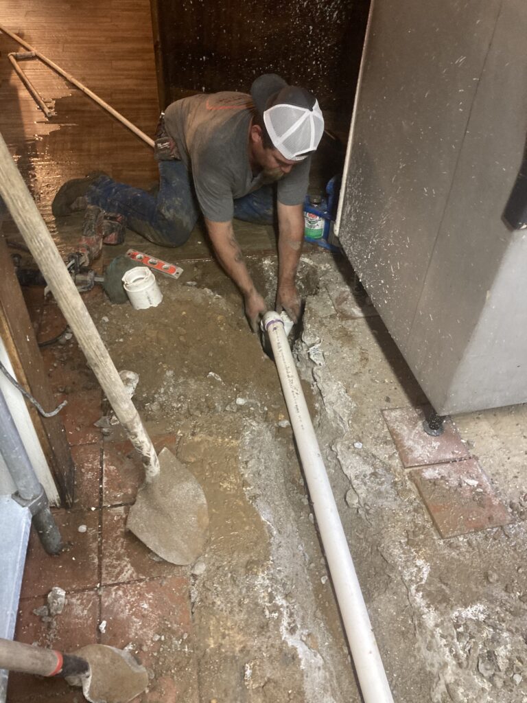 Plumber laying PVC pipe