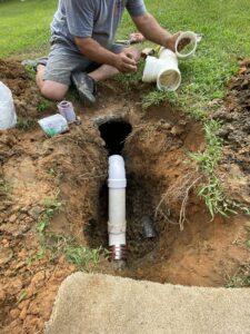Plumber working on underground pipes
