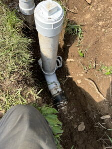 Sewer line repair being performed in yard