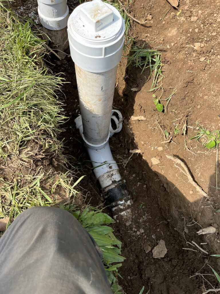 Sewer line repair being performed in yard