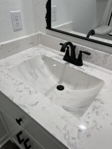 Technician replacing bathroom faucet handles