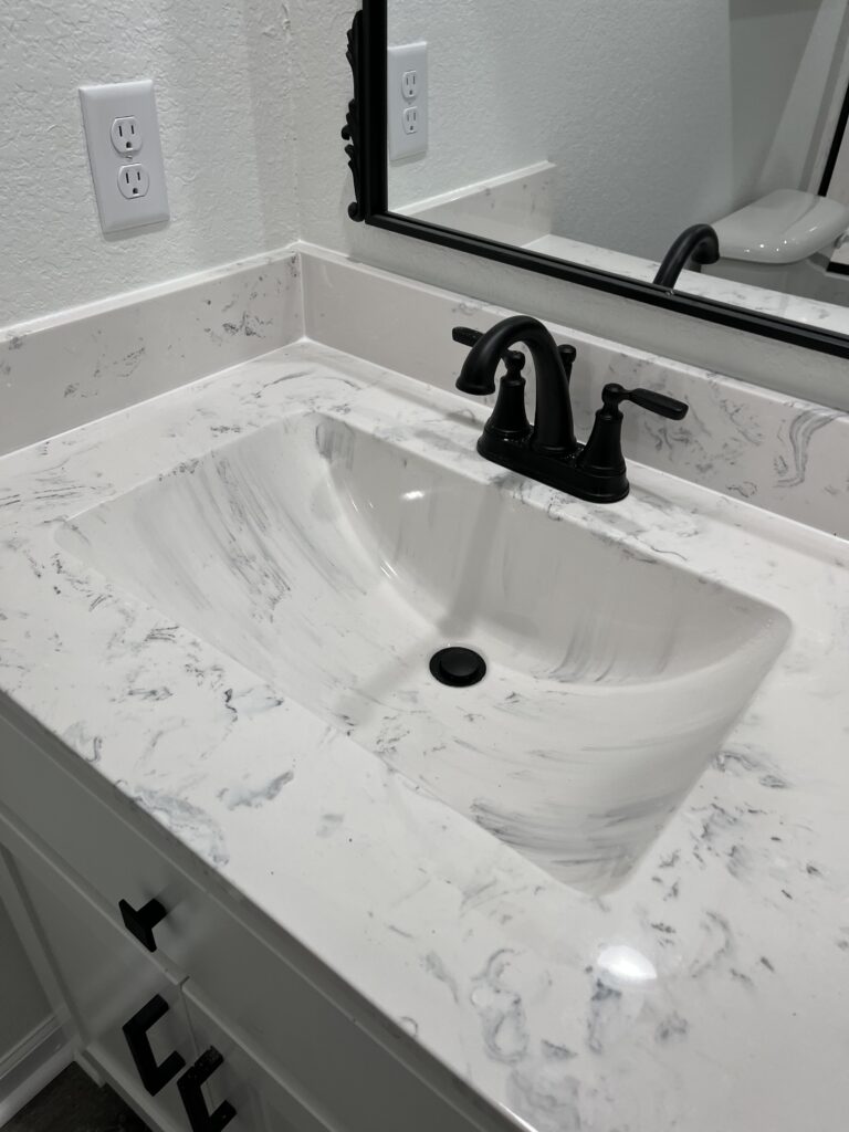 Technician replacing bathroom faucet handles