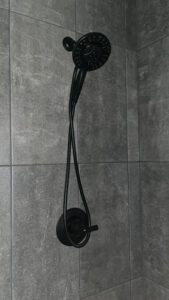 Technician tightening shower valve connection